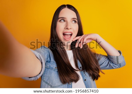 Close-up of young beautiful woman shoot selfie excited face look up