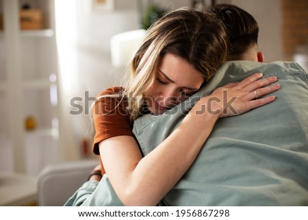 Young man having a problem. Girlfriend comforting her sad boyfriend. Royalty-Free Stock Photo #1956867298
