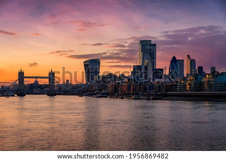 The skyline of the City of London, United Kingdom, with Tower Bridge and Thames river during dusk