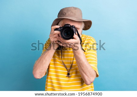 Photo of old man make picture focused digital camera hobby tourist isolated on pastel blue color background