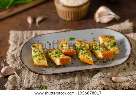 Delicious baguette with butter, parmesan cheese and garlic