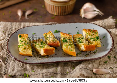 Delicious baguette with butter, parmesan cheese and garlic