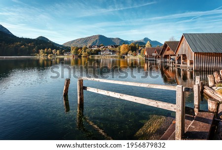 Amazing nature scenery. View on Alpine lake Grundlsee with Typical fishing huts in sunny day. Grundlsee is a one most popular travel locations in Europe. Wonderful Summer landscape. 
