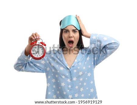 Emotional overslept woman with alarm clock on white background. Being late concept