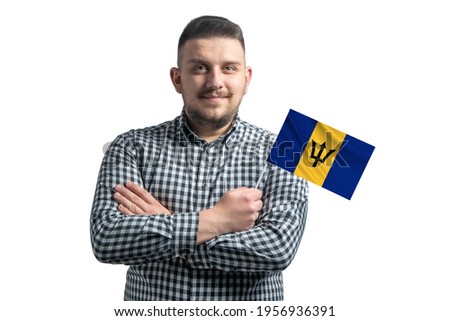 White guy holding a flag of Barbados smiling confident with crossed arms isolated on a white background.