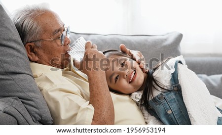 Little girl takes water to senior cancer patient. Adopted daughter takes care senior uncle, girl sleep on her uncle spends vacation time.