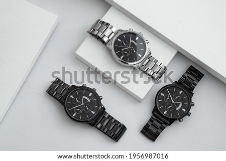 Luxury blacks and silver watch on white Table. Business man accessories