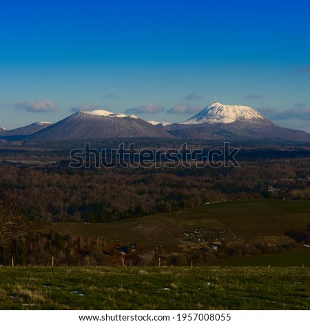 view of the two volcanoes: Puy-de-Dome and Puy-de-Come in snow. Auvergne Royalty-Free Stock Photo #1957008055