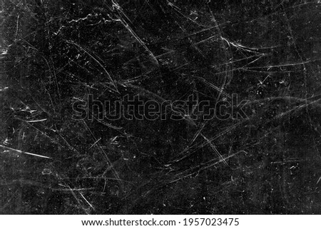 White scratches and dust on black background. Vintage scratched grunge plastic broken screen texture. Scratched glass surface wallpaper. Dirty Blackboard. Space for text.