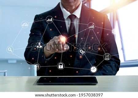 A man in a suit puts the index finger of his right hand pointing to press the center of the circle symbol. The meaning of online communication, shopping, messages, e-mail via the Internet network.