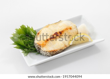 Grilled black cod or Gindara fish in plate on white background.