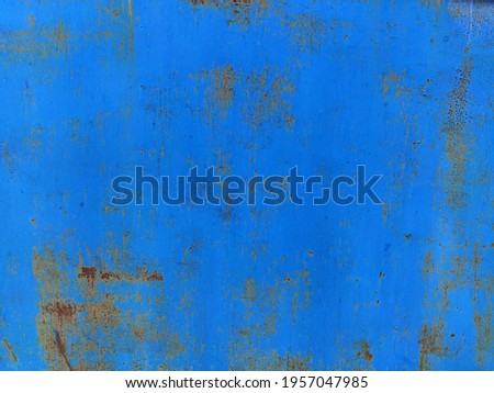 Rusty metal panel with cracked blue paint, corroded grunge metal background texture