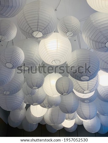 Ceiling with many paper round white chandeliers, interior ideas