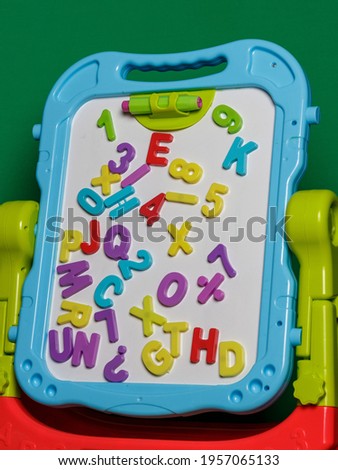 On the blue easel are letters and numbers for teaching young children.