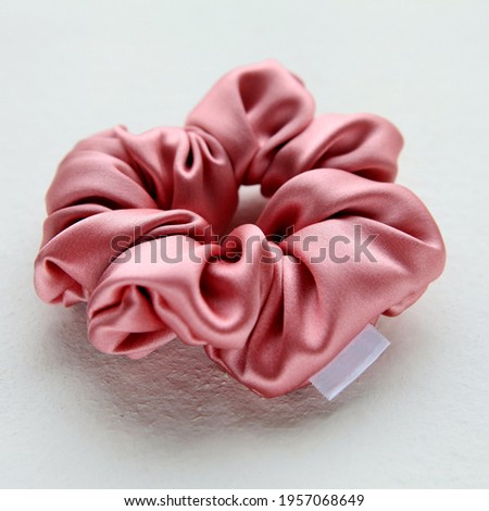 pink silk Scrunchy isolated on white background. Flat lay Hairdressing tool of Colorful Elastic Hair Band, Bobble Scrunchie Hairband Royalty-Free Stock Photo #1957068649