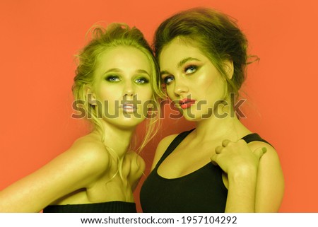 Two beautiful girls in the studio. Close-up