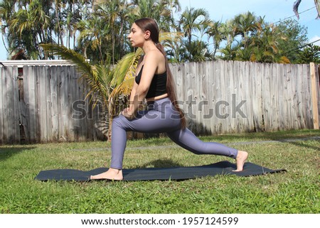 woman doing yoga in backyard