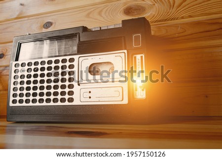 Old cassette tape recorder on wooden background