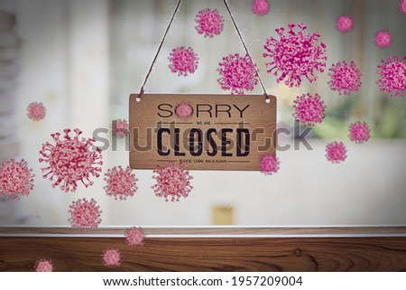 Sorry we are closed sign hanging on shop glass door. Covid-19 quarantine concept.
