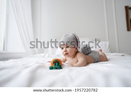 happy baby child in costume a rabbit bunny on a white background. High quality photo