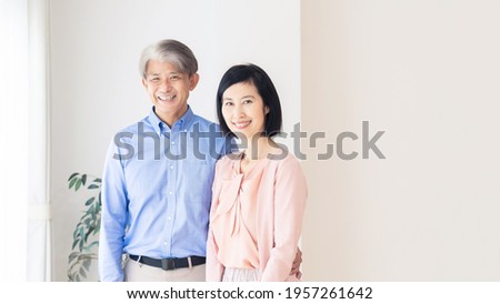 Middle aged asian couple in the house. Senior couple. Royalty-Free Stock Photo #1957261642