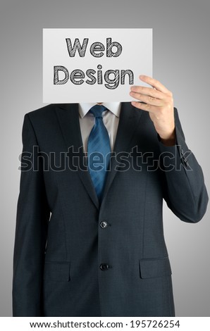 businessman holding a white sheet of paper with the inscription on grey background: web design
