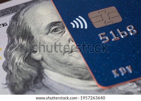 Debit card and US 100 dollar banknote for design purpose Royalty-Free Stock Photo #1957263640