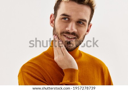 Cheerful man holding hand on face cropped view glamor close-up