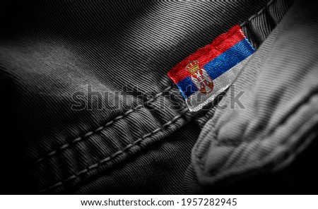Tag on dark clothing in the form of the flag of the Serbia
