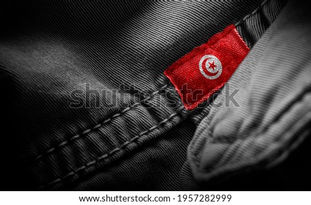 Tag on dark clothing in the form of the flag of the Tunisia
