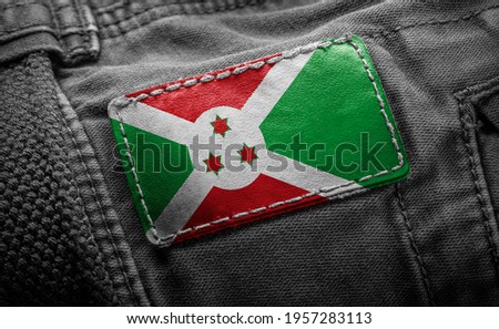Tag on dark clothing in the form of the flag of the Burundi