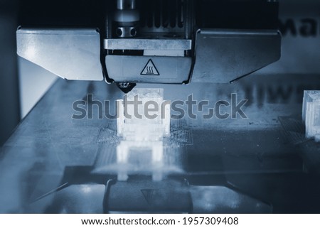 3D printer working and creating an object from the hot molten plastic