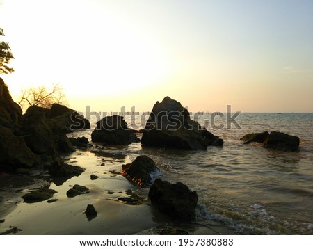 rock formations and body of water during Sunset