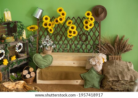 green wall with sunflowers and natural wood decorations Royalty-Free Stock Photo #1957418917