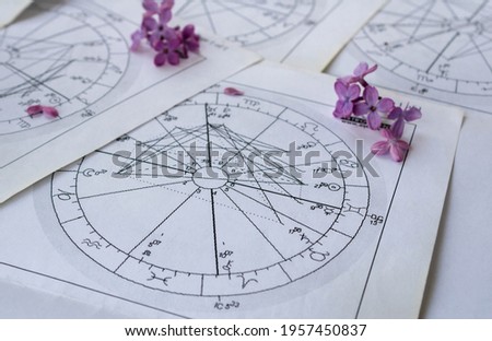 Printed astrology charts with tiny lilac flowers, springtime