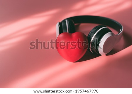 White Headphones and red heart on sweet pink background, Concept of listening music, Love, Relaxing time, Holly hobbie, Vintage retro, Pastel color of love for valentine day.