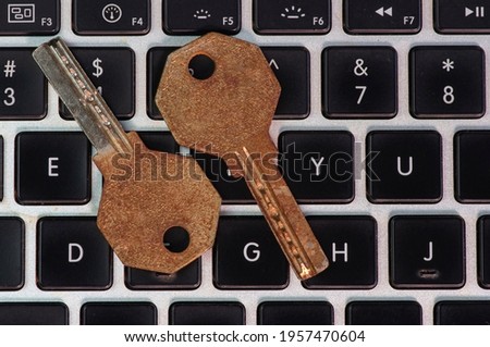 Old and rusty keys on laptop keyboard, computer security and password concept