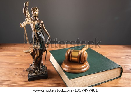 statue of justice and gavel on the table