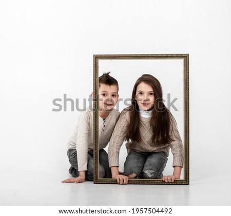 boy and girl posing with photo frames
