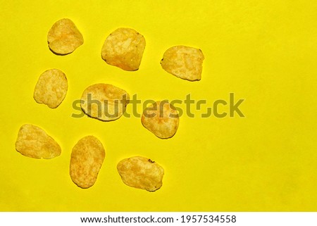 Chips pattern with copy space on a yellow background. Blank for a banner or article about fried potatoes.