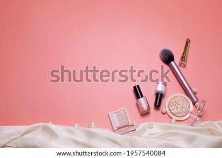 Pink beauty background with facial cosmetic, make-up products. Free space for text, copy space. Modern layout, top view, flat lay. Make up, skin care, beauty concept.
