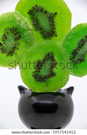 Bright green candied kiwi fruit with seeds close-up. Dried fruits. Candied kiwi.