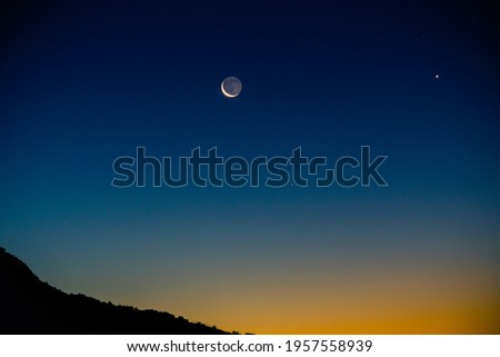 Crescent moon with earthshine and Venus rise with the mornings twilight in the desert..