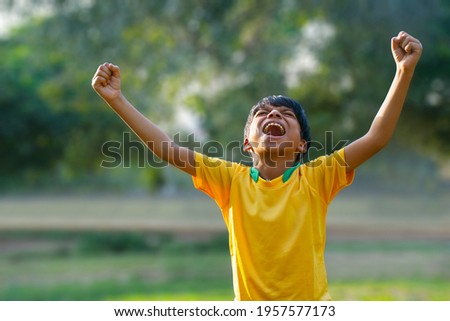 Excited boy football player after goal scored Royalty-Free Stock Photo #1957577173