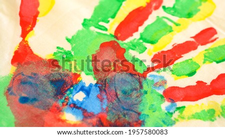 Watercolor paints. Traces of paint from the hands and fingers of children. Beautiful drawings of flowers. Art therapy. Hobby. Artists. Silhouettes of hands. Blue and green. Children's drawings. School