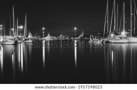 Long exposure picture of mediterranean sea with boats during the night