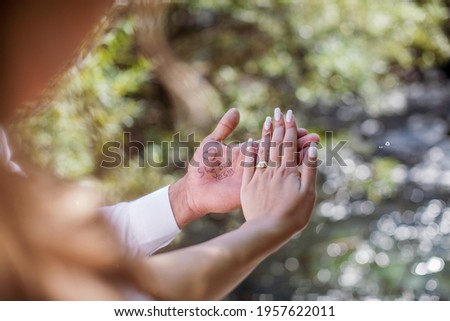"She said yes", couple hands with river in background Royalty-Free Stock Photo #1957622011
