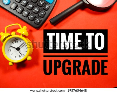 Text TIME TO UPGRADE on red background with clock,magnifying glass and calculator.Business concept.