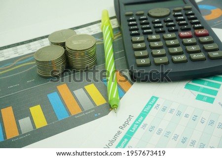 Calculator, coin and pencil on financial charts, business concepts