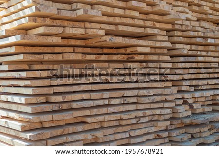 Boards are stacked evenly in rows. Oven dried boards.